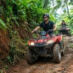 Traveler riding a quad bike on a tropical off-road trail at Alasan Adventure ATV Bali