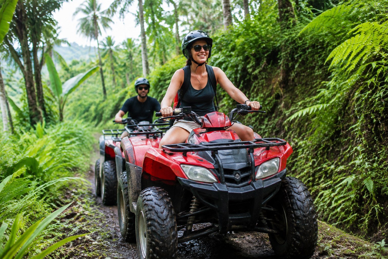 Traveler riding an ATV on a tropical jungle trail in Bali