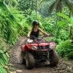 Traveler riding an ATV on a tropical trail near Ubud Bali