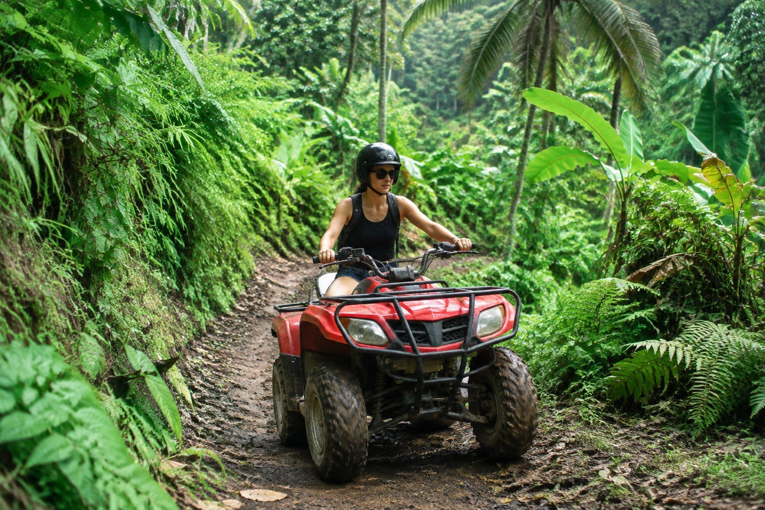 Traveler riding an ATV on a tropical trail near Ubud Bali